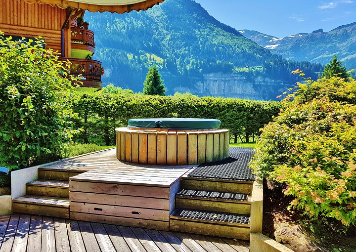 outdoor hot tub with views of the Swiss Alps