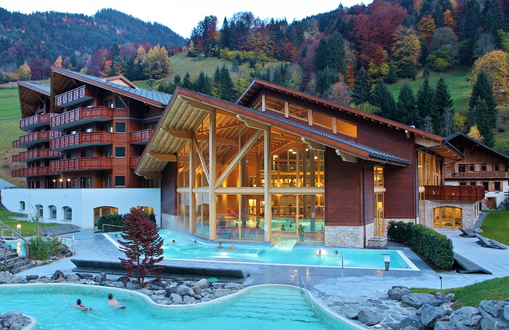 Thermes Par Spa building showing outdoor heated pools in the foreground